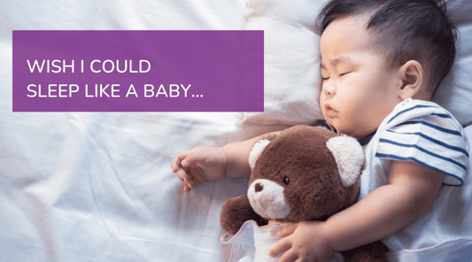 Image: Baby sleeping, cuddling a teddy bear. Test reads: WISH I COULD SLEEP LIKE A BABY.