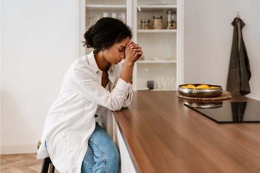 Woman sat at breakfast table low energy low mood