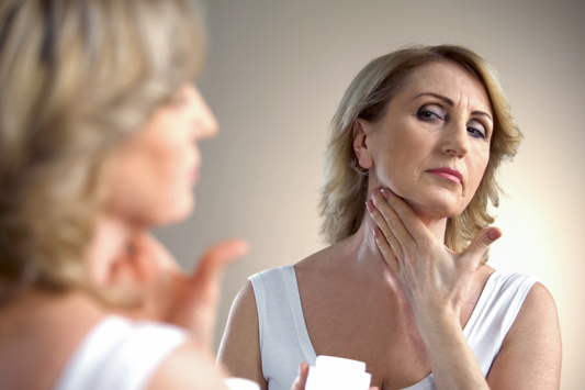 Woman frustrated with her makeup and wrinkles